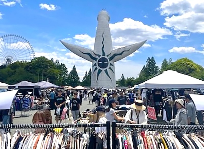 The Tower of the Sun look over racks of vintage clothing at Expo '70 Market